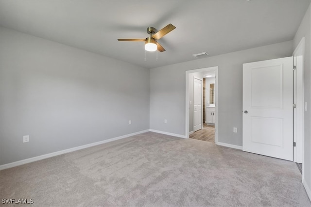 3225 58th St W, Lehigh Acres, FL 33971 - unfurnished bedroom featuring ensuite bathroom, visible vents, carpet flooring, a ceiling fan, and baseboards
