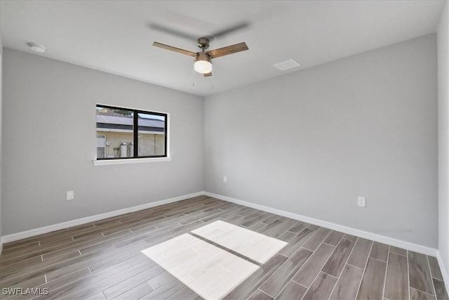 3225 58th St W, Lehigh Acres, FL 33971 - unfurnished room with ceiling fan, baseboards, and wood finished floors