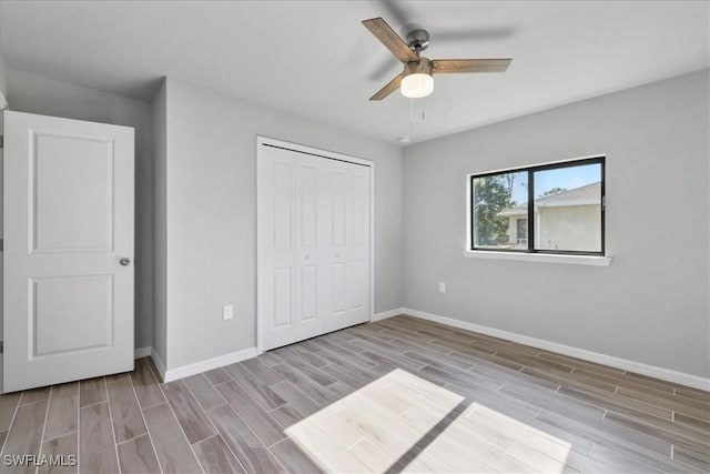 3225 58th St W, Lehigh Acres, FL 33971 - unfurnished bedroom featuring baseboards and wood tiled floor