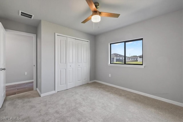 3225 58th St W, Lehigh Acres, FL 33971 - unfurnished bedroom featuring carpet flooring, a closet, visible vents, and baseboards