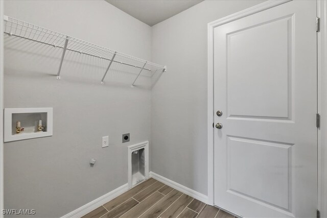 3225 58th St W, Lehigh Acres, FL 33971 - laundry room featuring wood tiled floor, baseboards, washer hookup, laundry area, and electric dryer hookup