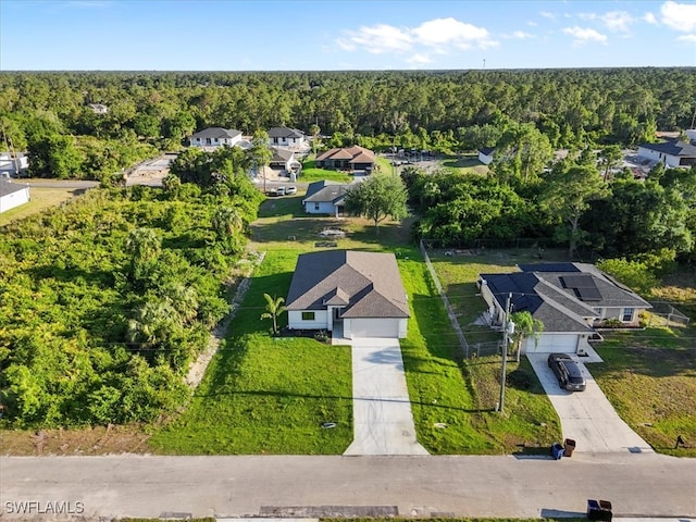 3225 58th St W, Lehigh Acres, FL 33971 - drone / aerial view featuring a residential view and a wooded view