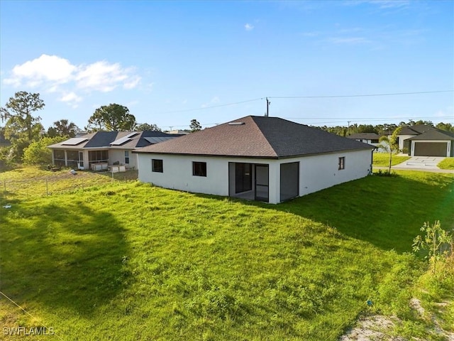 3225 58th St W, Lehigh Acres, FL 33971 - back of house featuring a yard, fence, and stucco siding