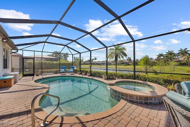 view of swimming pool with a patio area, a pool with connected hot tub, and a lanai