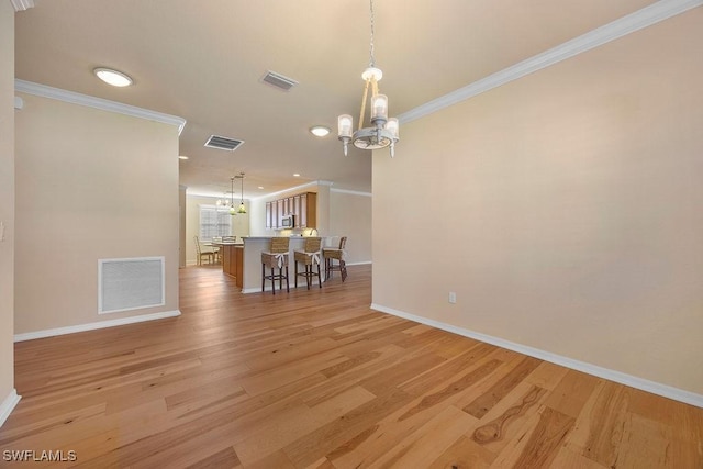 dining area with a chandelier, baseboards, crown molding, light wood finished floors, and recessed lighting