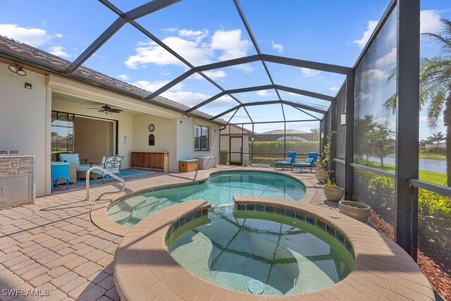 view of swimming pool with a patio, a pool with connected hot tub, ceiling fan, and a lanai