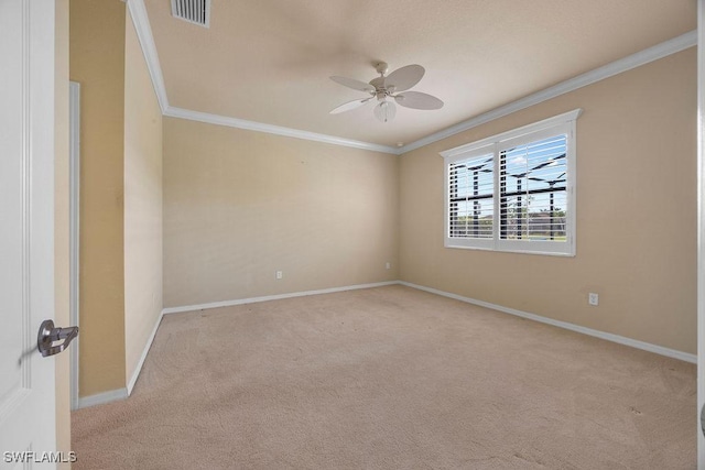 unfurnished room featuring crown molding, carpet flooring, a ceiling fan, and baseboards