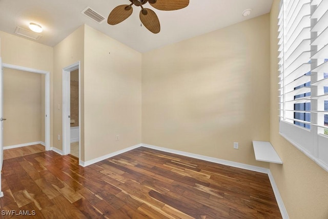 unfurnished room with ceiling fan, wood finished floors, and plenty of natural light