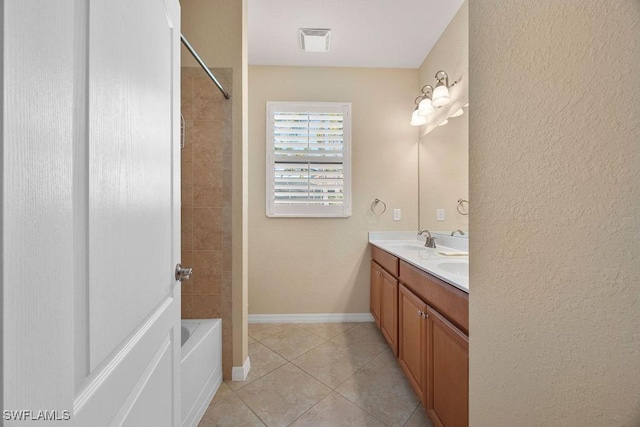 full bathroom featuring tile patterned flooring, double vanity, bathtub / shower combination, baseboards, and a textured wall