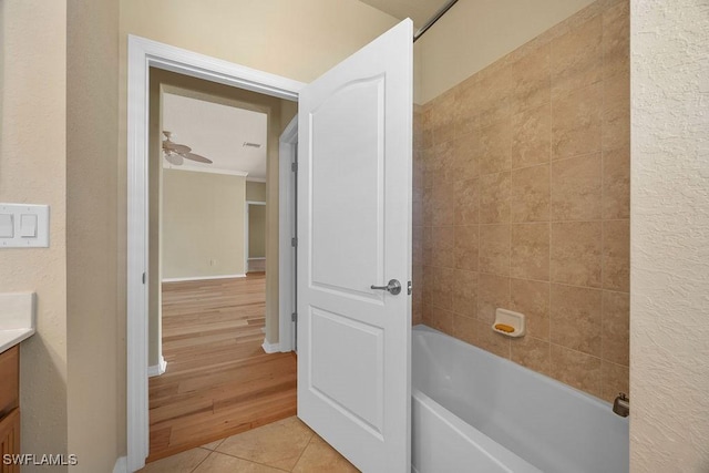 full bath with vanity, tile patterned floors, crown molding, bathing tub / shower combination, and baseboards