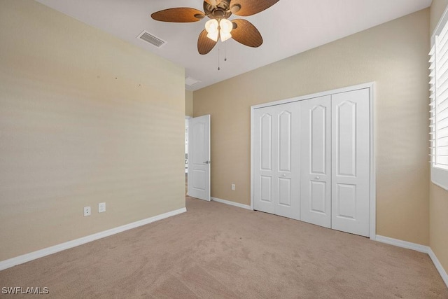 unfurnished bedroom featuring carpet floors, a closet, and baseboards