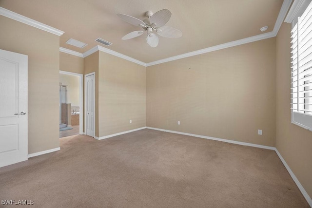 unfurnished bedroom with carpet floors, baseboards, crown molding, and ensuite bathroom