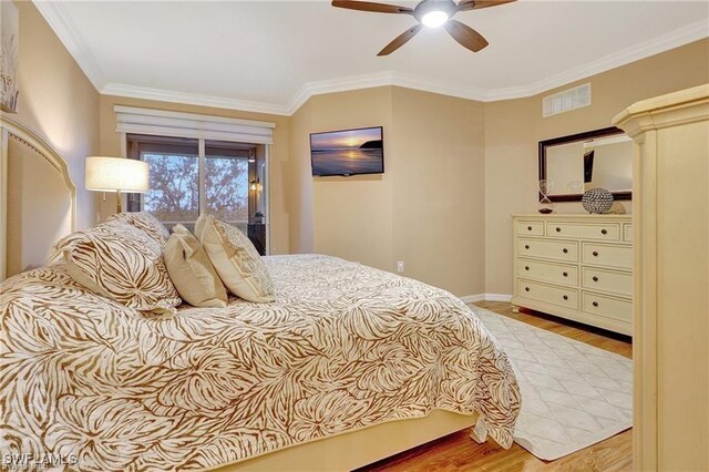 bedroom with a ceiling fan, wood finished floors, baseboards, ornamental molding, and visible vents