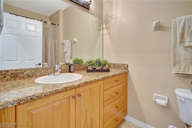 full bathroom featuring toilet and vanity