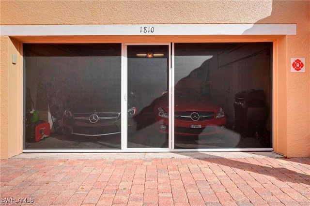 entrance to property featuring stucco siding