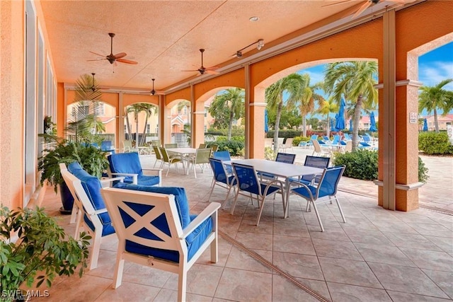 view of patio with outdoor dining space and a ceiling fan
