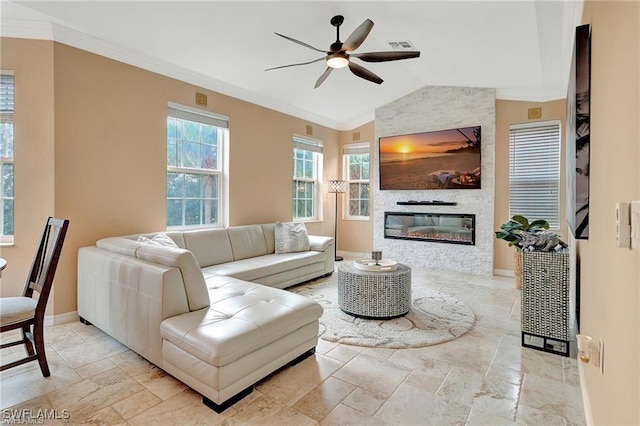 living area featuring stone tile floors, vaulted ceiling, a ceiling fan, crown molding, and baseboards