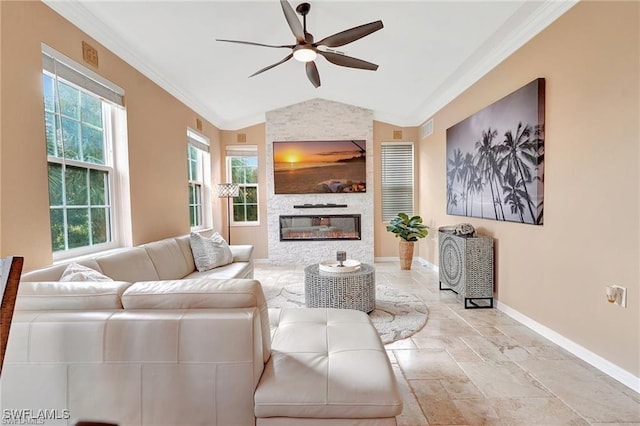 living area featuring plenty of natural light, vaulted ceiling, a ceiling fan, ornamental molding, and baseboards