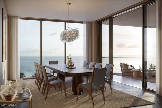 dining room with an inviting chandelier, a water view, and floor to ceiling windows