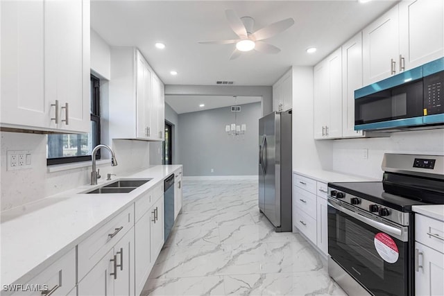242 Ground Dove Cir, Lehigh Acres, FL 33936 - kitchen with stainless steel appliances, a sink, light marble finish floors, a ceiling fan, and recessed lighting