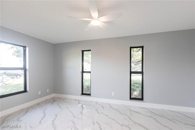 242 Ground Dove Cir, Lehigh Acres, FL 33936 - unfurnished room featuring baseboards, marble finish flooring, and a ceiling fan