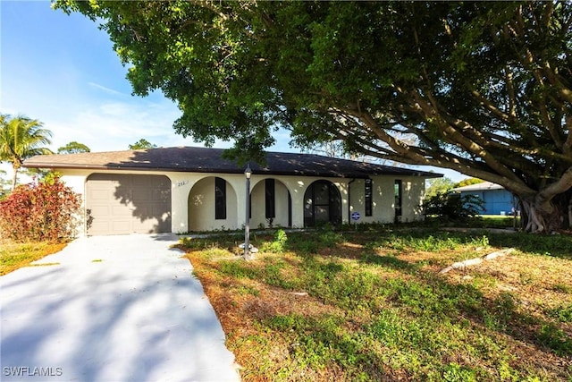 242 Ground Dove Cir, Lehigh Acres, FL 33936 - single story home with an attached garage, driveway, stucco siding, and a porch