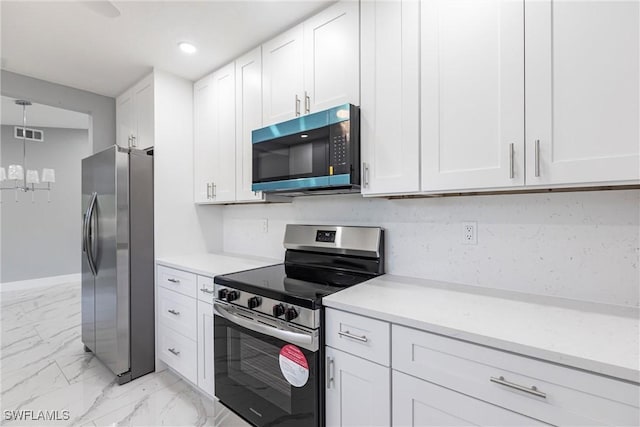 242 Ground Dove Cir, Lehigh Acres, FL 33936 - kitchen with appliances with stainless steel finishes, light marble finish flooring, white cabinets, and recessed lighting
