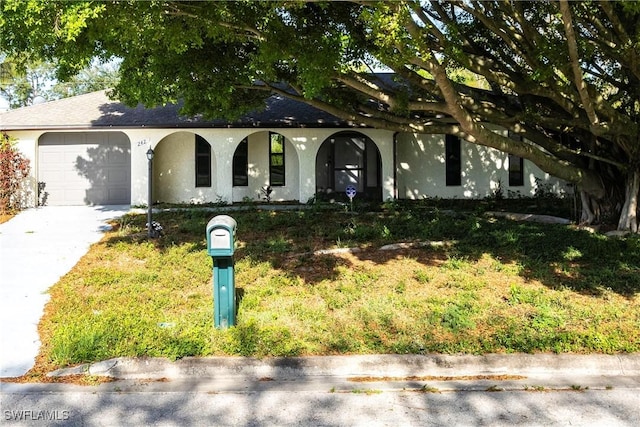 242 Ground Dove Cir, Lehigh Acres, FL 33936 - view of front of property with an attached garage, a porch, stucco siding, and driveway