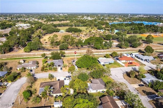 242 Ground Dove Cir, Lehigh Acres, FL 33936 - aerial view of residential area featuring a tree filled landscape
