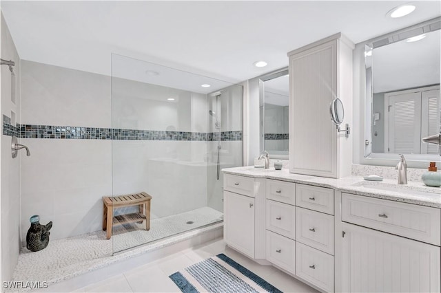2400 Gulf Shore Blvd N Unit 203, Naples, FL 34103 - bathroom featuring a walk in shower, tile patterned floors, double vanity, and recessed lighting