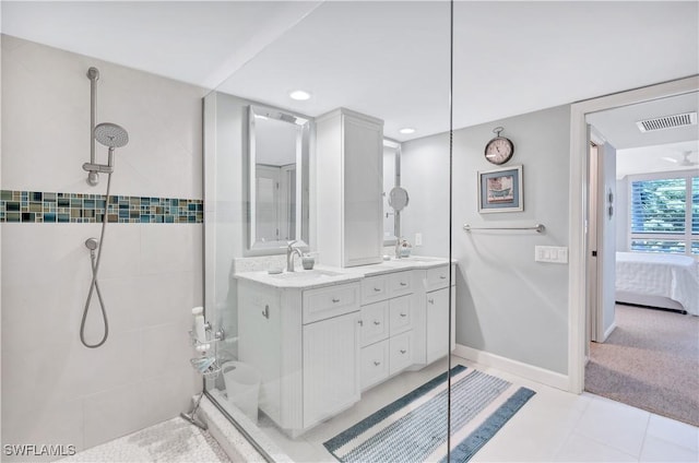 2400 Gulf Shore Blvd N Unit 203, Naples, FL 34103 - full bathroom featuring a tile shower, double vanity, ensuite bathroom, tile patterned floors, and recessed lighting