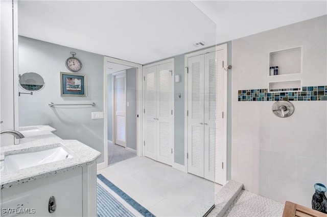 2400 Gulf Shore Blvd N Unit 203, Naples, FL 34103 - full bathroom featuring a closet, tiled shower, and double vanity