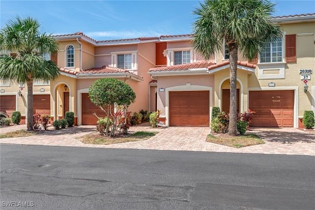20310 Estero Gardens Cir Unit 102, Estero, FL 33928 - mediterranean / spanish-style house featuring stucco siding, a tile roof, and driveway