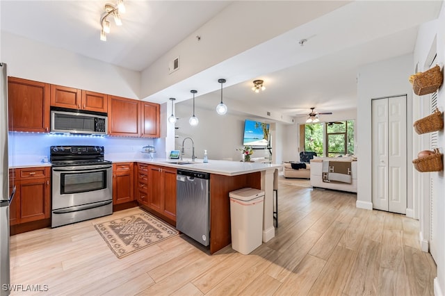 20310 Estero Gardens Cir Unit 102, Estero, FL 33928 - kitchen featuring stainless steel appliances, a peninsula, a sink, open floor plan, and visible vents