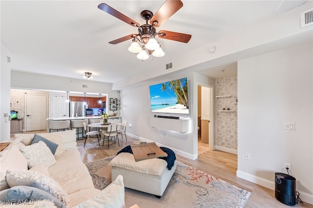 20310 Estero Gardens Cir Unit 102, Estero, FL 33928 - living room featuring baseboards, a ceiling fan, light wood-style floors, and visible vents