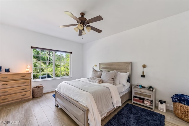20310 Estero Gardens Cir Unit 102, Estero, FL 33928 - bedroom with light wood-type flooring, baseboards, and ceiling fan