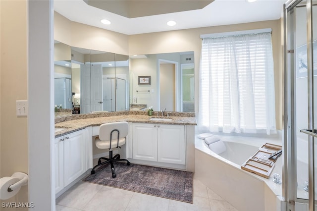 bathroom featuring tile patterned floors, double vanity, a bath, and recessed lighting