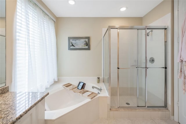 bathroom with a shower stall, a garden tub, vanity, and recessed lighting