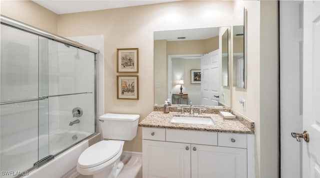 full bath featuring combined bath / shower with glass door, toilet, and vanity