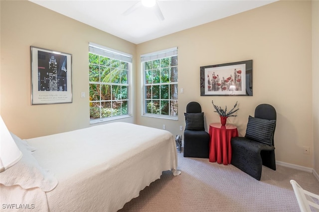 carpeted bedroom with baseboards and a ceiling fan