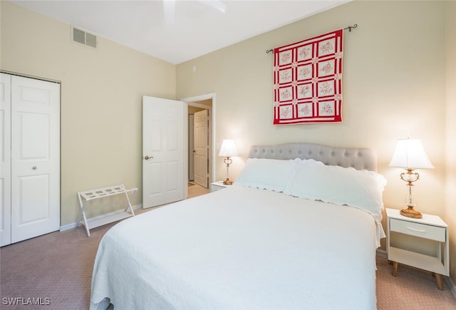 carpeted bedroom featuring a closet, baseboards, and a ceiling fan