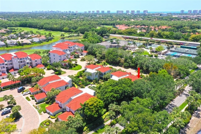 drone / aerial view of a nearby body of water and a skyline view