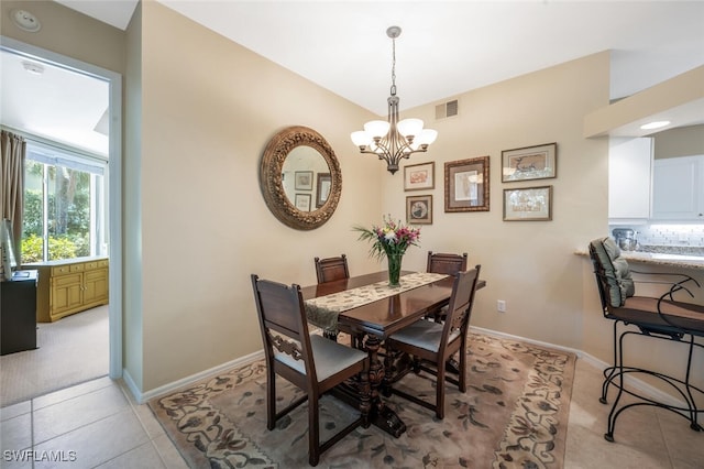 dining room featuring a chandelier, baseboards, and light tile patterned floors