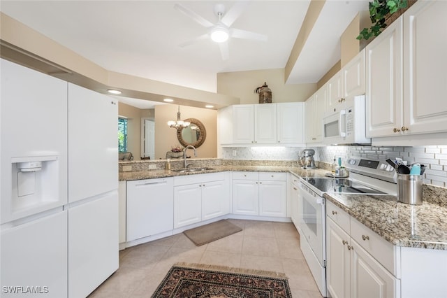 kitchen with white appliances, a sink, tasteful backsplash, and ceiling fan