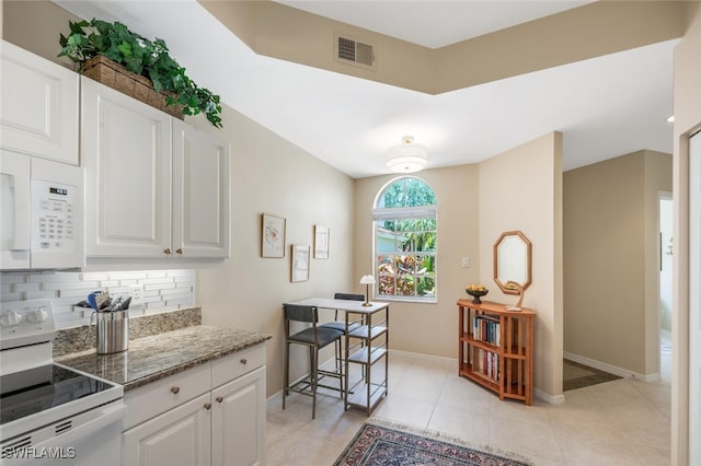 kitchen with white appliances, tasteful backsplash, baseboards, white cabinetry, and stone countertops