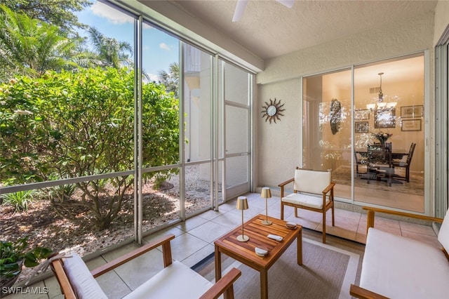 sunroom with a chandelier and healthy amount of natural light