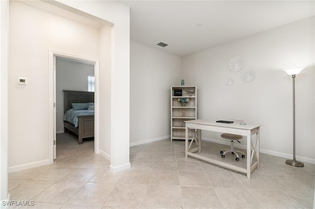 office with visible vents, baseboards, and light tile patterned floors