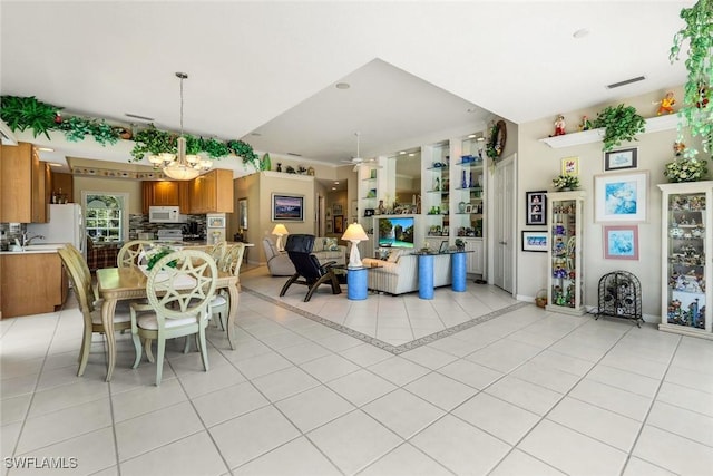 2783 Island Pond Ln, Naples, FL 34119 - dining area with ceiling fan with notable chandelier, visible vents, baseboards, and light tile patterned floors