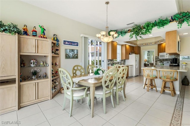 2783 Island Pond Ln, Naples, FL 34119 - dining space with light tile patterned flooring, a chandelier, and visible vents