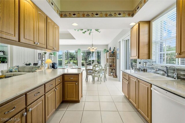 2783 Island Pond Ln, Naples, FL 34119 - kitchen featuring white dishwasher, a sink, light tile patterned floors, and a healthy amount of sunlight
